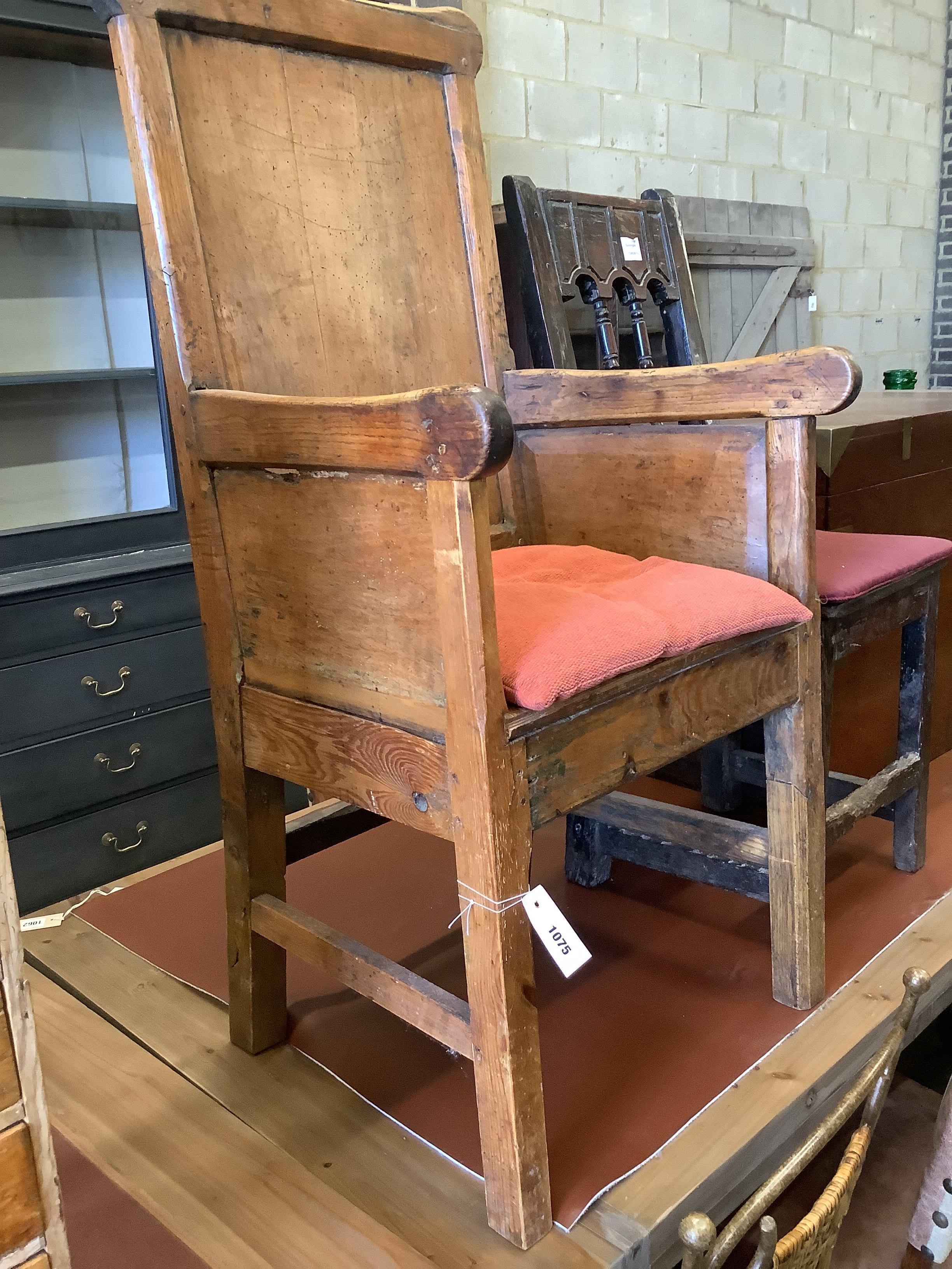 An 18th century stripped pine armchair and a dining chair